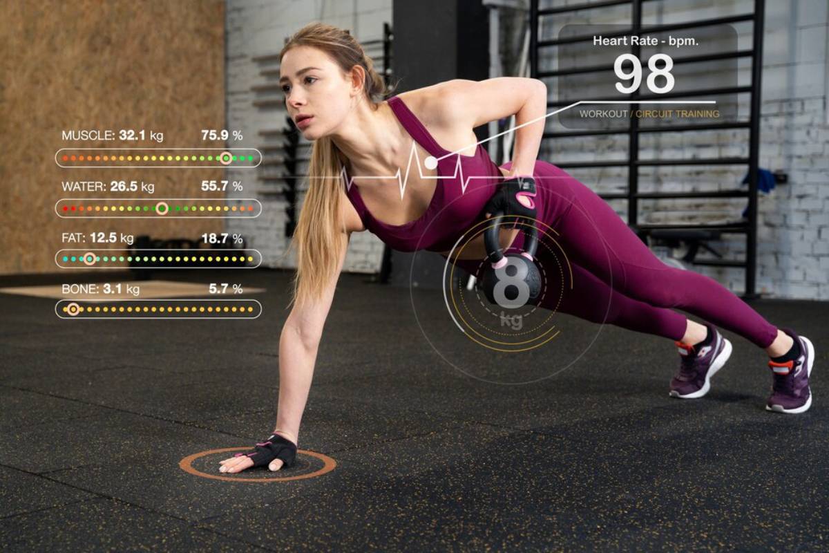 Woman in a gym doing a plank with augmented reality data displaying her exercise stats and health metrics.
