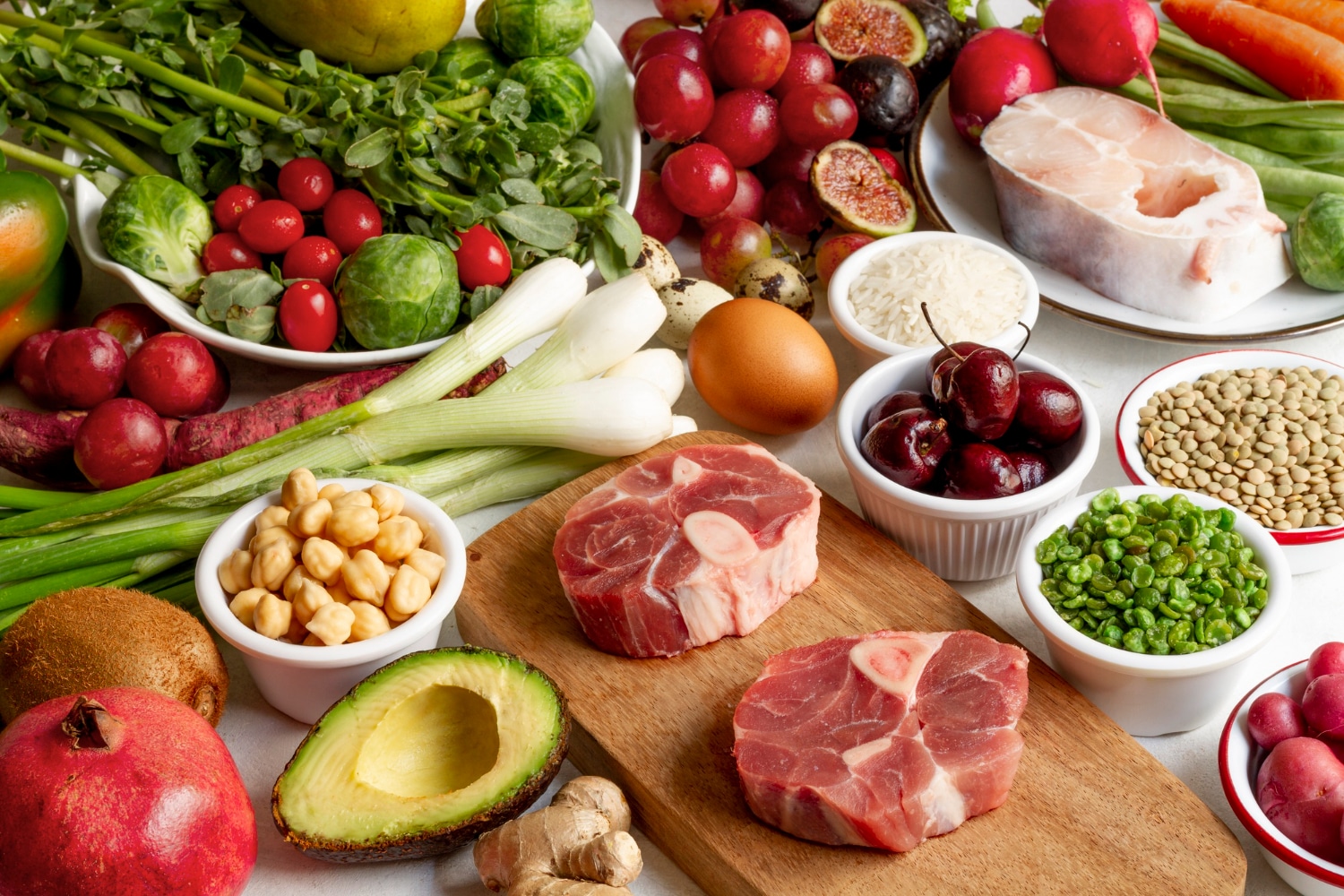 A vibrant display of fresh fruits, vegetables, meats, legumes, and grains